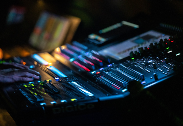 A close up of some lights on a sound board