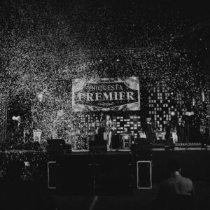 A black and white photo of people at a bar.