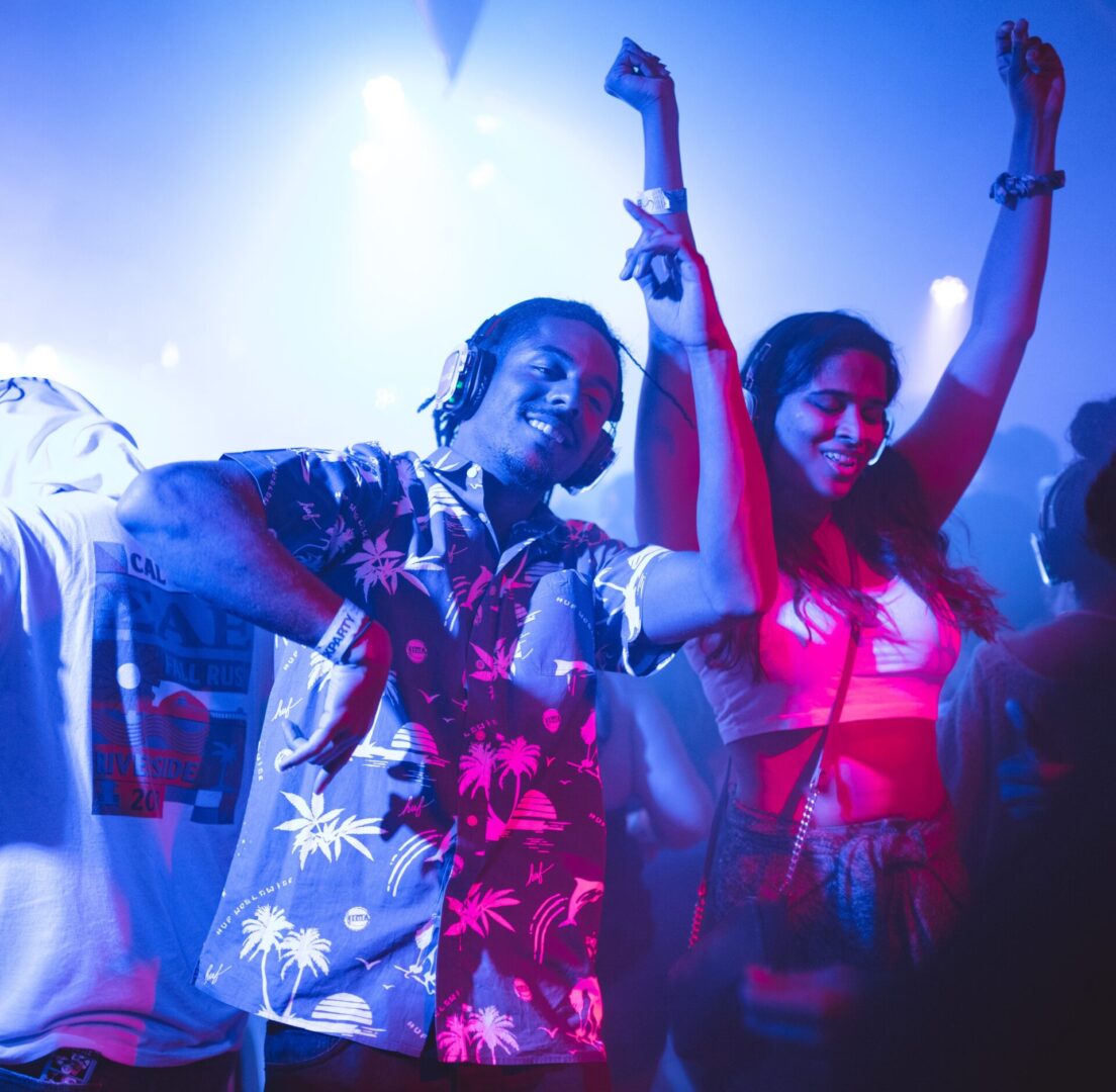 A group of people dancing in the dark.