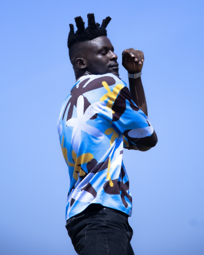 A man with a mohawk haircut is wearing a blue shirt.