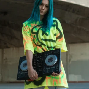 A woman with blue hair holding two dj turntables.
